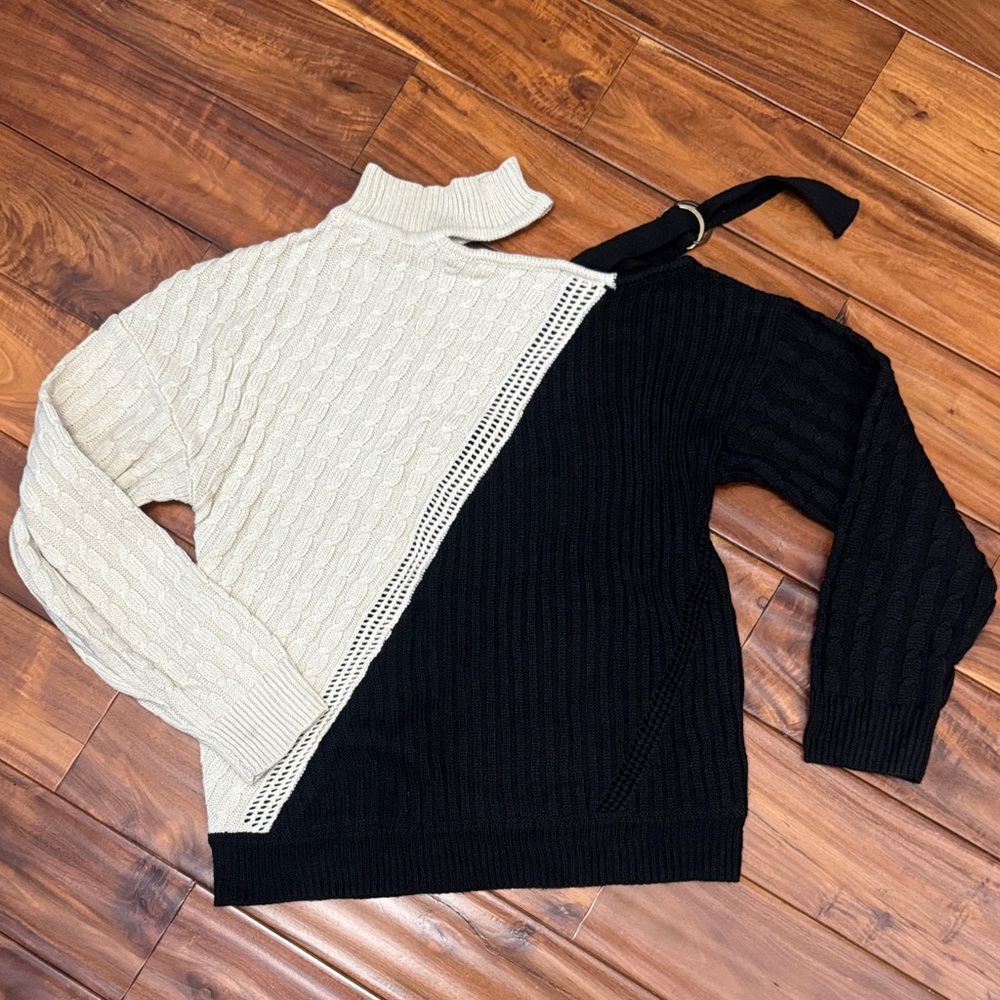 Two-Tone Black and Cream Women's Sweater with open shoulder strap.